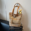 Brown woven straw tote bag with leather handles and tassel accent for summer beach style - Khaki