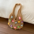 Detail of colorful 3D crochet flowers on a khaki hollow woven beach tote bag - Khaki
