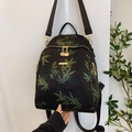 Black casual backpack with green leaf patterns and elegant gold hardware details - Black