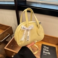 Lemon yellow shell-shaped handbag in lychee grain faux leather with a silk bow - Yellow