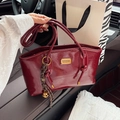 Vintage burgundy glossy shoulder bag with gold hardware and stylish bell charm detail - Red with Pendant