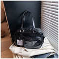 Detail of black glossy handbag with functional front pockets and transparent card slots - Black