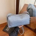 Light blue denim crossbody cylinder bag with a minimalist texture and zipper closure - Light Blue