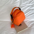 Bright orange nylon shell crossbody bag with double zip compartments and plush charm - Orange (With Pendant)