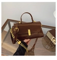 Detail of coffee brown leather mini bag featuring a gold rectangular lock and chain strap - Brown