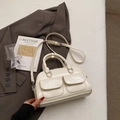 Chic cream-colored Boston handbag with dual front pockets and adjustable crossbody strap - Off White
