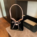Minimalist black patent leather bucket bag with pink bow detail and contrast lining - Black & Pink