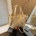 Beige lychee pattern bucket bag with elegant lace pearl charm and adjustable strap - Off-white