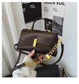Detail of chocolate brown square handbag with gold buckle and glossy leather finish - Coffee