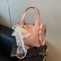 Pink lychee texture crossbody bucket bag with lace and pearl bow charm detail - Pink