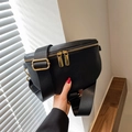 Crossbody chest bag in black pebble leather with gold hardware and wide nylon strap - Black