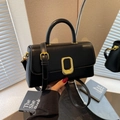 Minimalist black leather square handbag with golden oval clasp and adjustable strap - Black