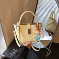 Creamy yellow leather bucket bag with cute doll charm and pearl chain decoration - Yellow with Pendant