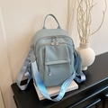 Chic light blue faux leather backpack with silver zippers and wide patterned strap - Blue
