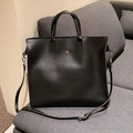 Minimalist black faux leather tote bag with silver button and adjustable crossbody strap - Black
