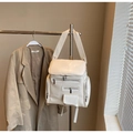 Close-up of cream white backpack with multiple metal zippers and large capacity design - Off-white