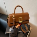 Minimalist dark brown leather crossbody bag with golden rectangular lock and top handle - Caramel color