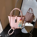 Pink faux leather bucket bag with silver twist lock and pearl doll charm accessory - Pink with Pendant