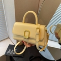 Elegant pale yellow square leather handbag with gold metal clasp and thin strap - Yellow