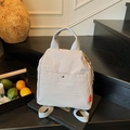 Minimalist beige lightweight nylon convertible backpack with red label on wooden stairs - Gray