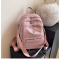 Detail of pink lychee texture backpack with triple-zipper layers and patterned shoulder strap - Pink