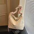 Minimalist cream white tote bag with pink pleated handle shown in natural light - Off White