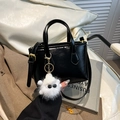 Elegant black bucket bag with a cute plush charm and adjustable golden hardware - Black with Pendant