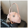Detailed close-up of pink glossy bowling bag with silver lock and pearl charm decoration - Pink with Pendant