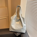 Light blue denim tote bag with white butterfly patterns and double handles on a sofa - Light Blue
