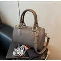 Detail of dark brown Boston bag with fine woven texture and gold-toned metal hardware - Meteorite Grey