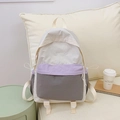 Close-up of color-block nylon backpack with drawstring pockets in a home setting - Purple
