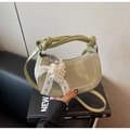 Detail of light green crescent bag with pearly heart charm and knotted strap - Green