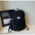 Détail du sac à dos en toile avec fermeture à cordon et boucles pour un rangement sécurisé - Noir