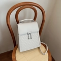 Chic beige handbag with triangular quilting and metal sphere chain detail on a chair - Off White