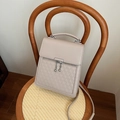 Beige faux leather backpack with geometric triangle patterns and silver hardware details - Khaki