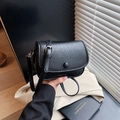 Classic black saddle bag in textured leather with adjustable shoulder strap for women - Black