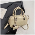 Dettaglio della borsa bowling beige con goffratura RO&SK e pendente a forma di cuore - Albicocca Con Pendente