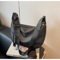 Detail of waterproof nylon crossbody bag showing wide adjustable strap and zipper closure - Black (Waterproof Membrane)