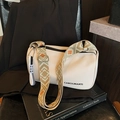 White crossbody pillow bag with CAROLMANTI logo and colorful geometric woven strap - Off White
