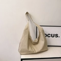 Minimalist beige canvas hobo tote bag with a spacious interior and soft shoulder strap - Khaki