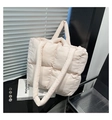 Close-up of quilted pink tote bag with padded handles and minimalist grid texture - Pink