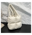 Detail of white quilted puffy handbag with soft padded nylon material and woven texture - White