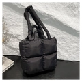 Chic black quilted puffer tote bag with wide handles for stylish daily commuting and travel - Black