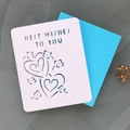 Detail showing laser-cut Best Wishes text and heart patterns on card with blue envelope - White Outer Card And Sky Blue Inner Page