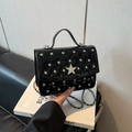 Elegant black quilted handbag with silver studs and a sparkling diamond star detail - Black