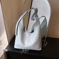 Elegant light blue hobo bucket bag with wrinkled faux leather texture and shoulder strap - Blue