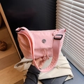 Minimalist pink nylon crossbody dumpling bag with wide shoulder strap and metal logo - Pink