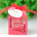 Macro shot of red laser-cut Eiffel Tower favor box with satin bow and thank you tag - Pearlescent Red
