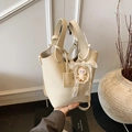 Chic beige lychee grain bucket bag with pearl and doll charms on a dual handle - With Charm / White