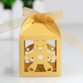 Detail of laser-cut hollow bear candy box in gold paper with a matching silk ribbon bow - Gold